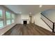 Bright living room with hardwood floors, fireplace, and large windows at 6272 Willow Branch Way, Plainfield, IN 46168