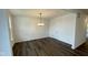 Bright dining room features hardwood floors and a modern chandelier at 6272 Willow Branch Way, Plainfield, IN 46168