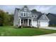Two-story house with gray siding, brick accents and landscaping at 6272 Willow Branch Way, Plainfield, IN 46168