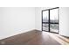 Bright bedroom with hardwood floors and large window at 855 N East St # 205, Indianapolis, IN 46202