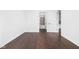 Bright bedroom with dark hardwood floors and access to hallway at 855 N East St # 205, Indianapolis, IN 46202