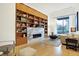 Spacious living area showcasing a marble fireplace and extensive built-in shelving at 855 N East St # 205, Indianapolis, IN 46202