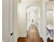 Long hallway with hardwood floors and arched ceilings at 7775 Ridge Rd, Indianapolis, IN 46240