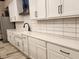 Modern white kitchen with black hardware and subway tile backsplash at 179 Velvet Hat Rd, Danville, IN 46122