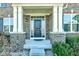 Covered porch entry with a dark door and brick columns at 2377 Chandler Way, Greenwood, IN 46143