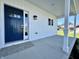 Front porch with a navy blue front door and white columns at 1692 Victor Dr, Martinsville, IN 46151