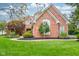 Two-story brick home with landscaped front yard at 13811 Driftwood Dr, Carmel, IN 46033