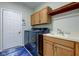 Laundry room with washer, dryer, cabinets, and built-in bench at 13811 Driftwood Dr, Carmel, IN 46033