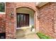 Inviting front entrance with a brick facade and elegant arched entryway at 13811 Driftwood Dr, Carmel, IN 46033