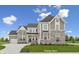 Two-story home with stone accents and a three-car garage at 15278 Quiet Trace Ct, Fishers, IN 46037