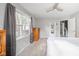 Main bedroom with gray walls and a striped bed, plus a window AC unit at 2015 Morton St, Anderson, IN 46016