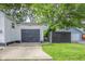 Single car garage with dark gray door and concrete driveway at 2015 Morton St, Anderson, IN 46016