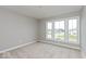 Bright bedroom with neutral walls and carpeting, featuring multiple windows at 19915 Chatham Green Dr, Westfield, IN 46074