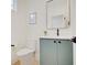 Stylish powder room with a teal vanity and a modern toilet at 1544 Hoyt Ave, Indianapolis, IN 46203