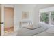Bedroom with large window, light gray bedding, and walk-in closet at 1544 Hoyt Ave, Indianapolis, IN 46203