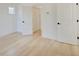 Bright bedroom featuring light hardwood floors and ample closet space at 1544 Hoyt Ave, Indianapolis, IN 46203