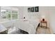 Bedroom with large window, plush bedding, and wood floors at 1544 Hoyt Ave, Indianapolis, IN 46203