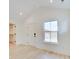 Bedroom with light hardwood floors, a closet, and exterior access at 1544 Hoyt Ave, Indianapolis, IN 46203