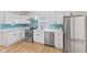 Modern kitchen with white cabinets and teal backsplash at 249 N Beville Ave, Indianapolis, IN 46201