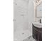 Bathroom with a walk-in shower and dark vanity at 249 N Beville Ave, Indianapolis, IN 46201