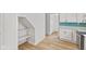 Modern kitchen with white cabinets and teal backsplash at 249 N Beville Ave, Indianapolis, IN 46201