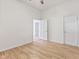 Simple bedroom with hardwood floors and two doors at 249 N Beville Ave, Indianapolis, IN 46201