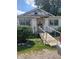 Front view of a modest house with a wooden ramp and landscaping at 2220 S Burke St, Indianapolis, IN 46231
