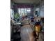 Sunroom with wicker furniture, plants, and wood floors at 2220 S Burke St, Indianapolis, IN 46231