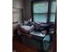 Small bedroom with a daybed and window with blinds at 2220 S Burke St, Indianapolis, IN 46231