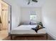 Cozy bedroom with a queen bed, light walls, and a window with blinds at 1134 St Peter St, Indianapolis, IN 46203