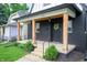 Inviting front porch features stylish wood posts and a black brick exterior at 1134 St Peter St, Indianapolis, IN 46203