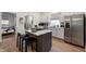 Modern kitchen with island, stainless steel appliances, and light wood flooring at 1134 St Peter St, Indianapolis, IN 46203