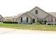 Stone exterior home with shutters, landscaping, and manicured lawn at 2148 Heather Glen Way, Franklin, IN 46131