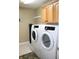 Laundry room with Samsung washer and dryer, and upper cabinets at 2148 Heather Glen Way, Franklin, IN 46131