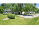 Stone house with a large tree and gravel driveway at 11445 N School St, Fishers, IN 46038