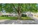 Stone house with a large tree and two-car garage at 11445 N School St, Fishers, IN 46038