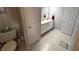 Clean bathroom with double vanity and updated tile flooring at 7433 Prairie Lake Dr, Indianapolis, IN 46256