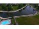 Aerial view of community pool, pond with fountain, and lush green spaces at 7433 Prairie Lake Dr, Indianapolis, IN 46256