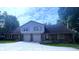 Two-story brick and vinyl home with attached two-car garage and driveway at 7433 Prairie Lake Dr, Indianapolis, IN 46256