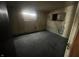 Unfinished basement with stained carpet and walls at 2327 Hoyt Ave, Indianapolis, IN 46203
