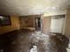 Dirty and damaged living room with debris on floor at 2327 Hoyt Ave, Indianapolis, IN 46203