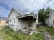 White sided house with covered porch needs repairs at 2327 Hoyt Ave, Indianapolis, IN 46203
