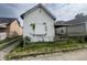 A small white house needing renovation, in need of repairs at 2327 Hoyt Ave, Indianapolis, IN 46203