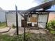 Damaged detached garage with exposed framing at 2327 Hoyt Ave, Indianapolis, IN 46203