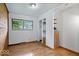 Bedroom with wood-paneled wall and hardwood floors at 9996 N County Road 200 W, Muncie, IN 47302