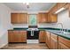 Kitchen with wood cabinets, green countertops, and a stove at 9996 N County Road 200 W, Muncie, IN 47302