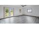 Spacious living room with gray vinyl flooring and French doors at 9996 N County Road 200 W, Muncie, IN 47302