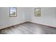 Well-lit bedroom featuring hardwood floors and two windows at 9996 N County Road 200 W, Muncie, IN 47302