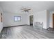 Simple living room with gray vinyl flooring and ceiling fan at 9996 N County Road 200 W, Muncie, IN 47302