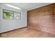 Bedroom with wood-paneled wall and hardwood floors at 9996 N County Road 200 W, Muncie, IN 47302